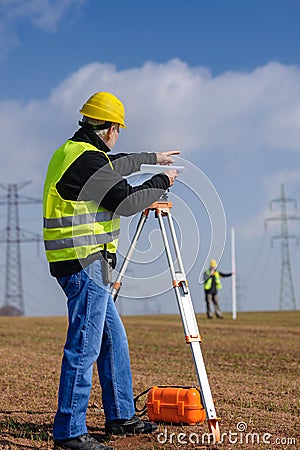 Geodesist measure land point direction Stock Photo