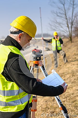 Geodesist read plans on construction site Stock Photo