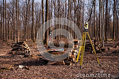 Geodesy, theodolite on a tripod in forest Stock Photo