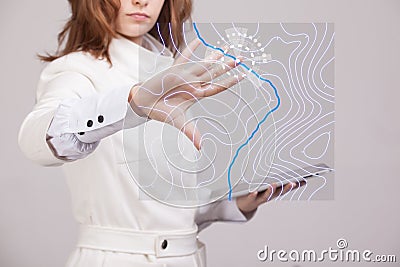 Geographic information systems concept, woman scientist working with futuristic GIS interface on a transparent screen. Stock Photo