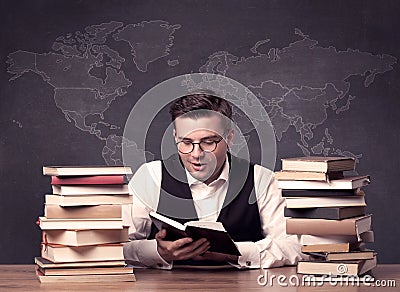 Geography teacher at desk with pile of books Stock Photo