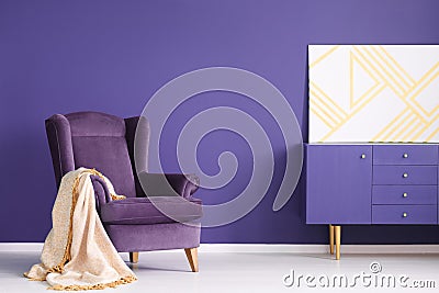 Geometric painting on a purple cabinet in elegant living room in Stock Photo