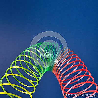Geometric parabola from colored slinky toy. Editorial Stock Photo