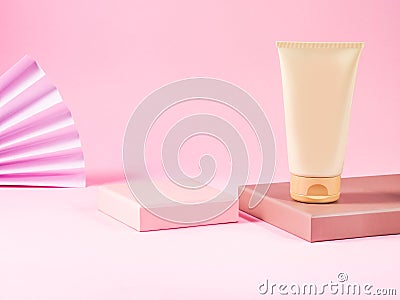 Geometric podium displays body care generic cream tube on pink background. Stock Photo