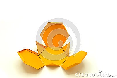 Geometric shape cut out of yellow paper and photographed on white background.Geometry net of Truncated tetrahedron Stock Photo