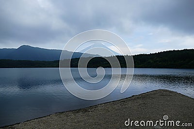 Geometric view with coast in the foreground and small hills and Mount Fuji in the background, Japan Stock Photo
