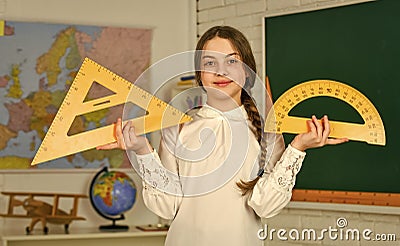 Geometry favorite subject. measure angles in degrees. Small child girl use protractor and triangle for geometry lesson Stock Photo