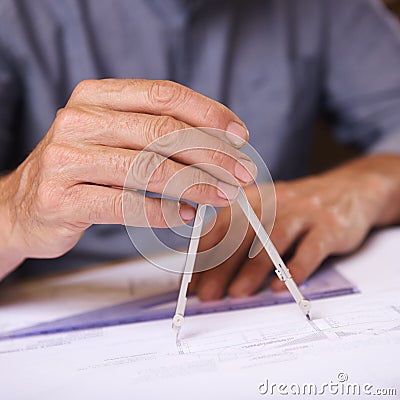 Geometry matters. Closeup shot of a draftsman using a triangle and compass to draw up building plans. Stock Photo