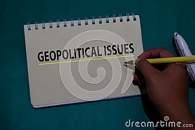 Geopolitical Issues write on a book isolated on Office Desk Stock Photo