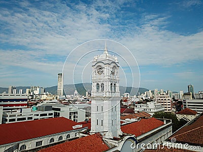 Clock Tower at Malayan Railway Building with background KOMTAR tower. Editorial Stock Photo