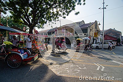 Rickshaw driver at the bicycle friendly street. Editorial Stock Photo