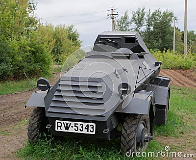 German armoured personnel carrier of world war II in black camouflage on a leafy background . Editorial Stock Photo