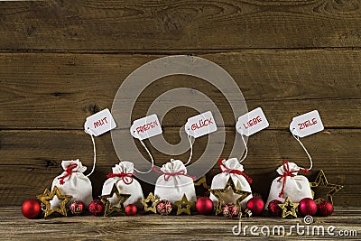 German christmas greetings with presents and text on wooden back Stock Photo