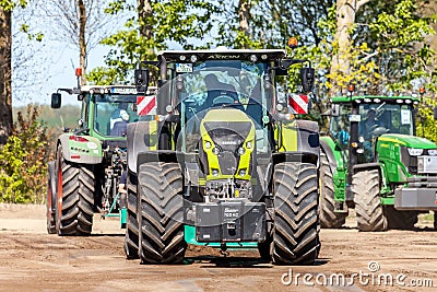 German claas axion tractor drives on track by a traktor pulling event Editorial Stock Photo