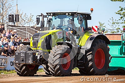 German claas axion tractor drives on track by a traktor pulling event Editorial Stock Photo