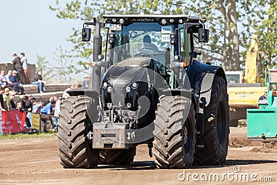 German claas axion tractor drives on track by a traktor pulling event Editorial Stock Photo