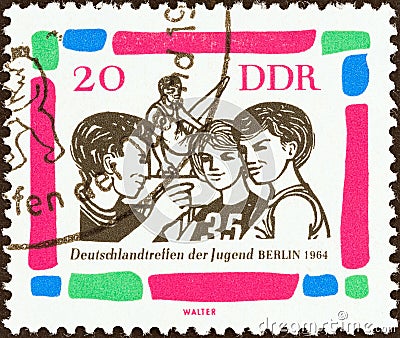 GERMAN DEMOCRATIC REPUBLIC - CIRCA 1964: A stamp printed in Germany shows Young gymnasts, circa 1964. Editorial Stock Photo