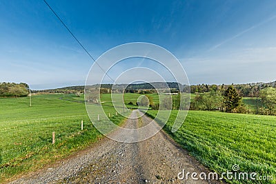 German Eifel landscape with road and green slopes Stock Photo