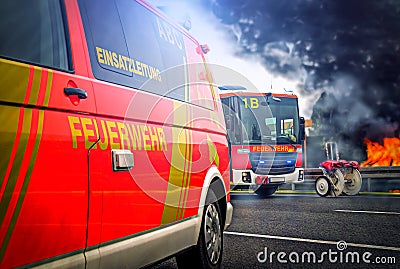 German firefighting trucks stands on a street near a fire Stock Photo