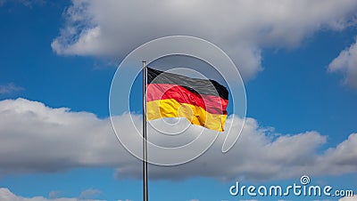 German flag waving on a flagpole against blue sky with clouds, Stock Photo