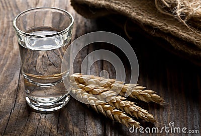 German hard liquor Korn Schnapps in shot glass with wheat ears Stock Photo