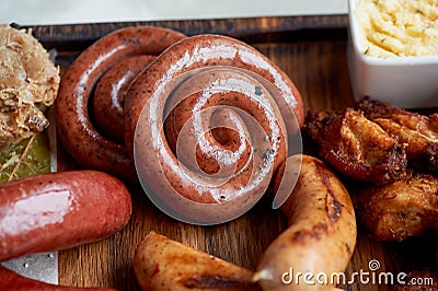 German hearty lunch in the pub.Grilled sausages, stewed cabbage, croutons, sauce. Beer snack Stock Photo