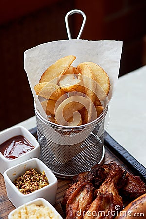 German hearty lunch in the pub.Grilled sausages, stewed cabbage, croutons, sauce. Beer snack Stock Photo