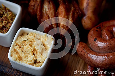 German hearty lunch in the pub.Grilled sausages, stewed cabbage, croutons, sauce. Beer snack Stock Photo