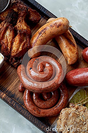 German hearty lunch in the pub.Grilled sausages, stewed cabbage, croutons, sauce. Beer snack Stock Photo