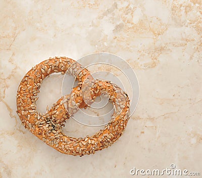 German pretzel sprinkled with seeds on the marble table. top vie Stock Photo