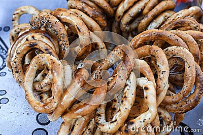 German pretzels stack one over each other, group of thin dry pretzels on rope Stock Photo