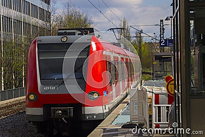 German S-bahn train arriving to the train stop, Munich Stock Photo