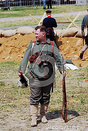 German soldier-reenactor stand holding a gun. Editorial Stock Photo