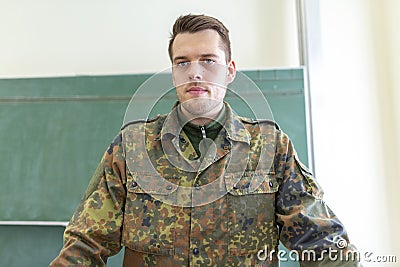 German soldier stands in a classroom Stock Photo