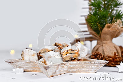 German Stollen cake pieces, a fruit bread with nuts, spices, and dried fruits with powdered sugar Stock Photo