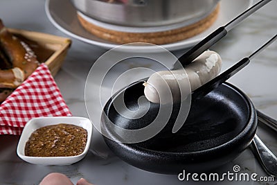 German WeiÃŸwurst sausage in pot, Bavarian sweet mustard and pretzel Stock Photo