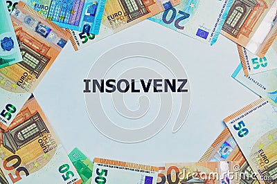 German word for insolvency printed on a white paper with Euro banknotes around Stock Photo
