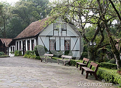 Germanic-style house and benches to sit Editorial Stock Photo
