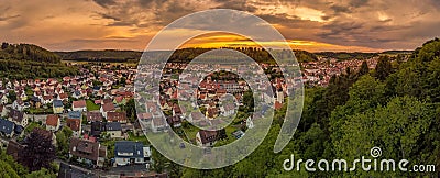 Germany, Albstadt at the Schwaebische Alb skyline of medieval city illuminated by the dawn, aerial view above roofs and Stock Photo