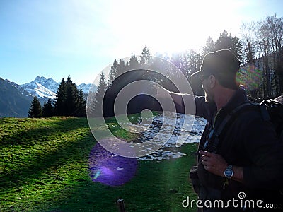 Germany. Alps. Oberstdorf. A hiker in the mountains stands in the sun. Stock Photo