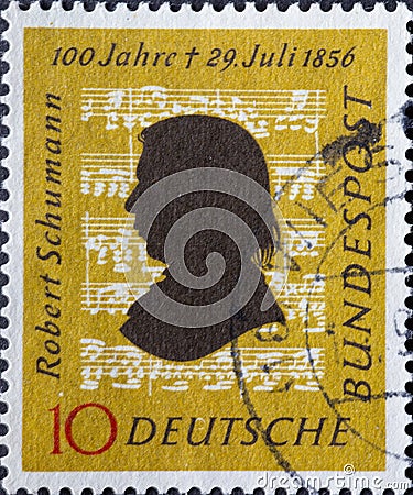 GERMANY - CIRCA 1956: This postage stamp in ocher yellow shows the portrait of the composer Robert Schumann against the background Editorial Stock Photo