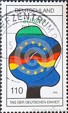 GERMANY - CIRCA 1998 : a postage stamp from Germany, showing a graphic of a tree with the German and European flags and the silhou Editorial Stock Photo