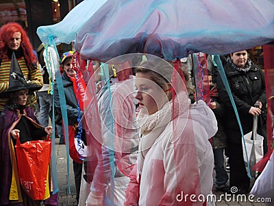 funny costumed group consisting of young women. In the background costumed spectators Editorial Stock Photo