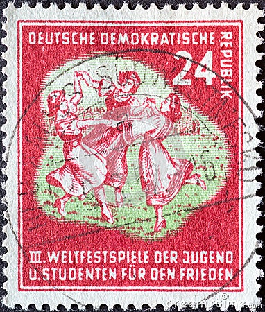 GERMANY, DDR - CIRCA 1951 : a postage stamp from Germany, GDR showing a folk dance group. III. World Festival of Youth and Student Editorial Stock Photo