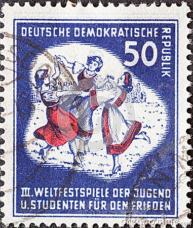 GERMANY, DDR - CIRCA 1951 : a postage stamp from Germany, GDR showing a folk dance group. III. World Festival of Youth and Student Editorial Stock Photo