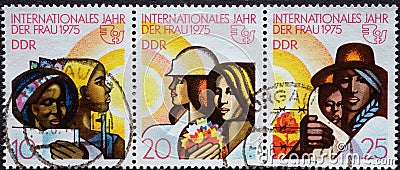 GERMANY, DDR - CIRCA 1975 : a postage stamp from Germany, GDR showing some women of different nations, emblem of the UN for the in Editorial Stock Photo