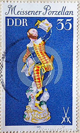 GERMANY, DDR - CIRCA 1979 : a postage stamp from Germany, GDR showing an antique classic figure harlequin with beer mug. Meissen Editorial Stock Photo