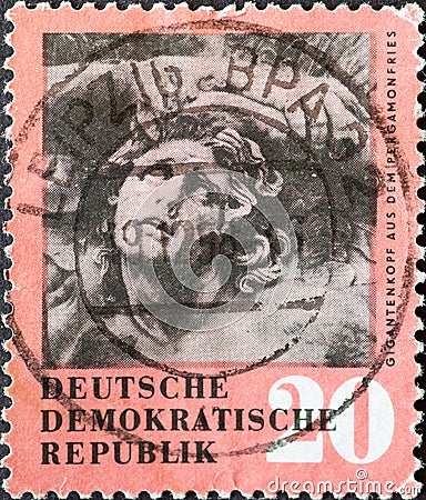 GERMANY, DDR - CIRCA 1958 : a postage stamp from Germany, GDR showing a giant head from the frieze of the Pergamon Altar in Berlin Editorial Stock Photo