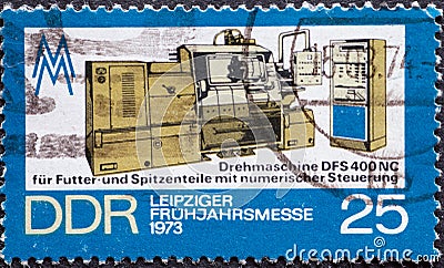 GERMANY, DDR - CIRCA 1973 : a postage stamp from Germany, GDR showing a Lathe with numerical control Text: Leipziger spring fair 1 Editorial Stock Photo