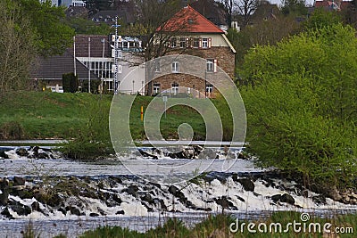 View from the bank of the barrage of the river Ruhr to the Restaurant country home Editorial Stock Photo